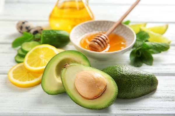 honey with a fresh avocado and sliced lemons honey with a fresh avocado and sliced lemons