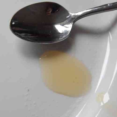 honey and spoon on a plate honey and spoon on a plate