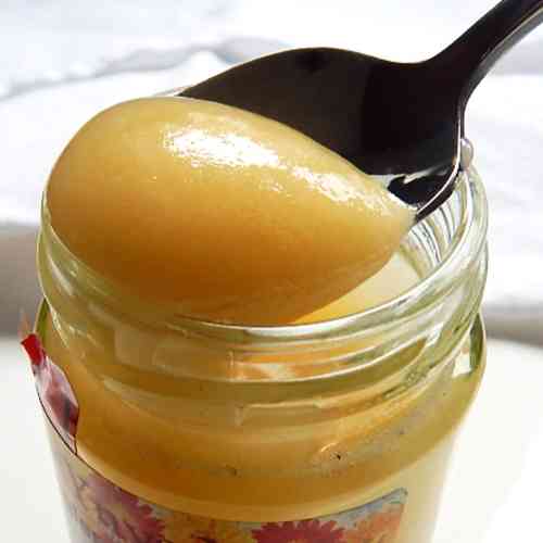 Spoon of soft set honey being taken from a jar. Spoon of soft set honey being taken from a jar.
